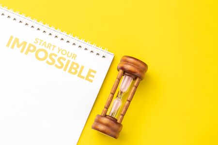 Close up vintage hourglass or sandglass on new year calendar for planning concept