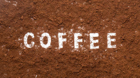 Close up ground coffee from coffee machine isolated on white backgroundの写真素材