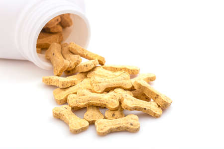 Close up pile of calcium for dog in white bottle isolated on white backgroundの写真素材