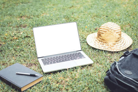 Asian tourist working and using laptop at Sukhothai historical park, Thailand. Vacation and holiday...