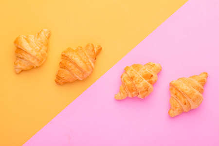 Top view mini Croissant in wooden dish on yellow background. Food concept with copy spaceの写真素材