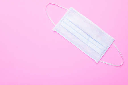 Top view new protective face mask on bright pink backgroundの写真素材