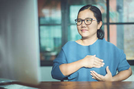 Breast Cancer concept : Asian woman looking computer screen to learning about checking breast by...