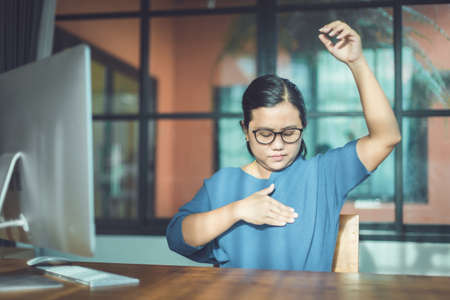 Breast Cancer concept : Asian woman looking computer screen to learning about checking breast by herselfの写真素材