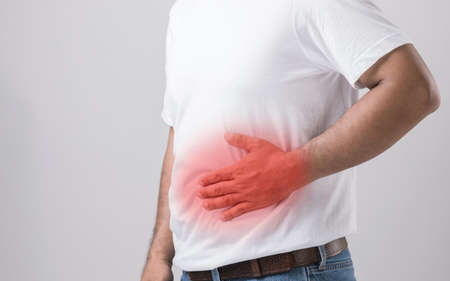 Liver or kidney problem concept : Close up man holding hand on belly and feeling a pain in liver or...
