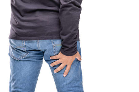 Body pain concept : Man holding on his back thigh that feeling pain. Studio shot isolated on white...
