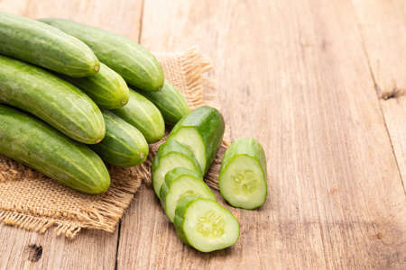 Close up pile and slice cucumber on wooden table background. Food and healthcare conceptの写真素材