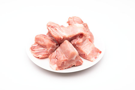 Raw Pork Bone Spine in white dish isolated on white backgroundの写真素材
