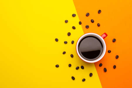 Top view black coffee or Americano in red cup isolated on yellow background