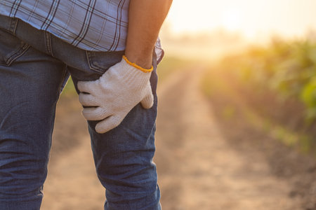 Injuries or Illnesses, that can happen to farmers while working. Man is using his hand to cover over...