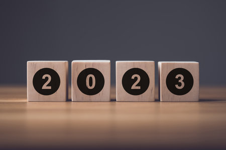 Number 2023 write on wooden blocks and arranged on office wooden table. Use for the idea of start up for new Learning, Education or working in 2023 Concept, Studio shot.の写真素材