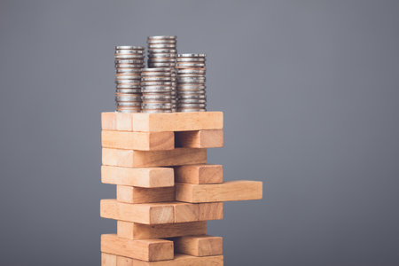 Risks in business or financial concept. Idea to prevent risk in business. Business man playing and selective right or risky piece of tower wooden block game and prevent falling down. Studio shot.の写真素材