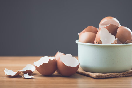 A pile of eggshells sits on a table against a gray background, symbolizing the potential benefits of...