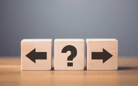 Forward and backward arrows on wooden blocks, symbolizing the concept of thought development. The process of reflecting on past actions while progressing toward future growth and improvementの写真素材