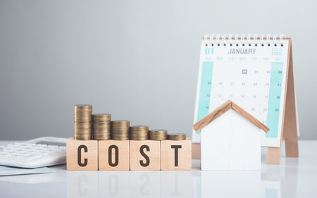 House model, a stack of coins, and a calendar symbolize the concept of home repair planning and budgeting. Organizing repair schedules and preparing financial resources for upcoming maintenanceの写真素材