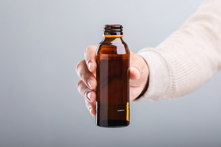 Man holds a bottle energy drink, prompting the question of its health impact-whether it boosts energy or has potential downsides. A reflection on making mindful choices for well-beingの写真素材