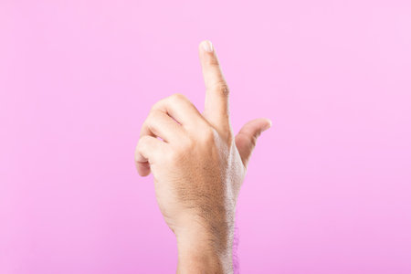 Hand displays various gestures, including a fist, open palm, and raised fingers, against a pink background. A visual exploration of communication through hand symbolsの写真素材