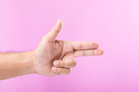 Hand displays various gestures, including a fist, open palm, and raised fingers, against a pink background. A visual exploration of communication through hand symbolsの写真素材