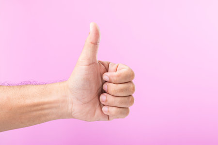 Hand displays various gestures, including a fist, open palm, and raised fingers, against a pink background. A visual exploration of communication through hand symbolsの写真素材