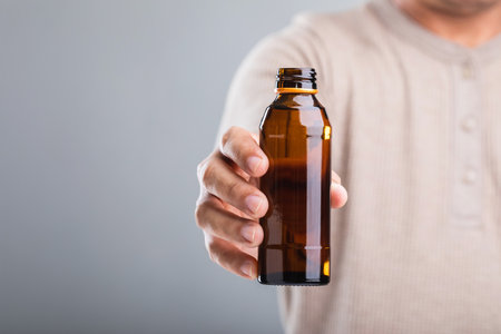 Man holds a bottle energy drink, prompting the question of its health impact-whether it boosts energy or has potential downsides. A reflection on making mindful choices for well-beingの写真素材