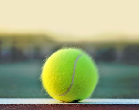 Tennis ball on clay court baselineの写真素材