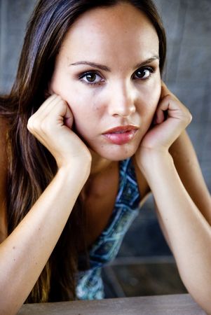Beautiful woman with head in handsの写真素材