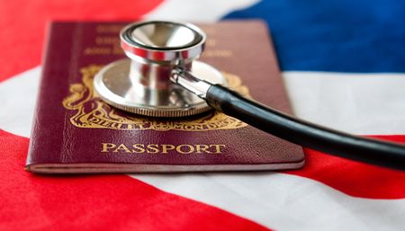 Stephoscope on passport. Health care in United Kingdom and EU. の写真素材