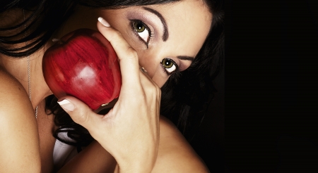 Exotic beautiful woman holding red apple の写真素材
