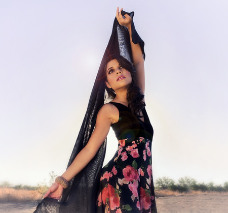 Beautiful elegant woman in desert sunlight の写真素材