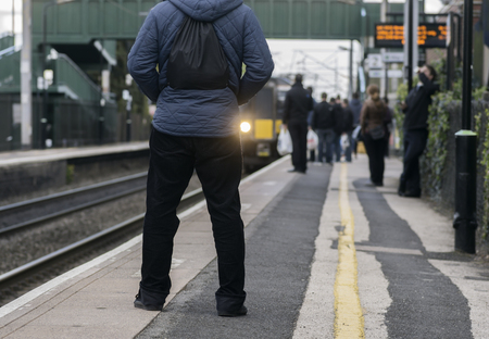 Young Man waiting on train station