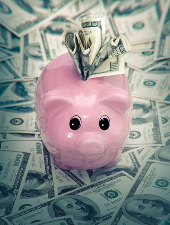Piggy bank stuffed with moneyの写真素材