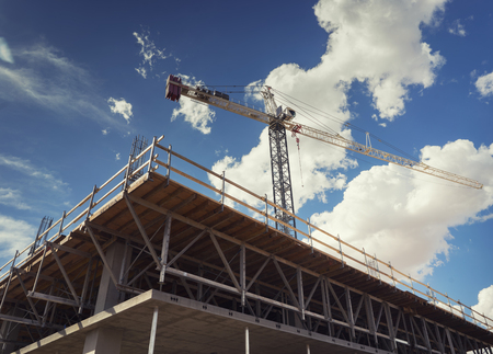Construction site with cranes on sky background