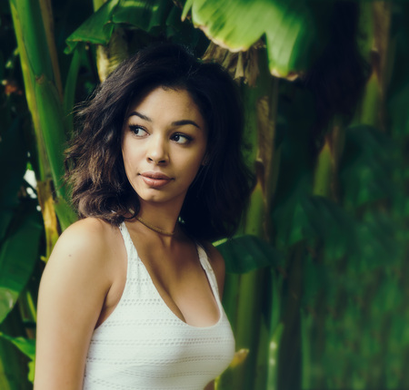 Beautiful exotic young woman looking backの写真素材