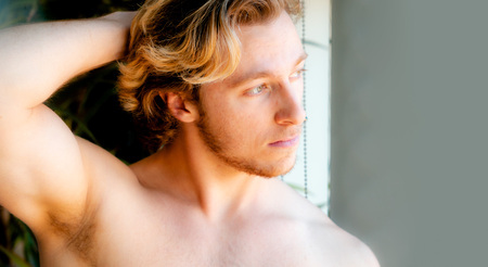 Athletic built young man - male model head and shoulder portraitの写真素材