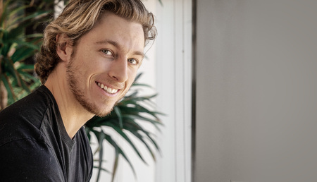 Smiling happy young man's face