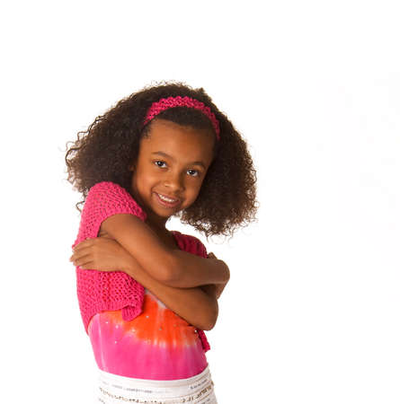 Smiling happy little girl with beautiful curly frizzy hairの写真素材