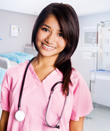 Portrait of a smiling nurse with stethoscope in a hospitalの写真素材