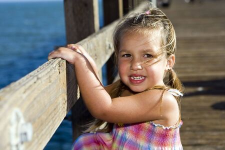 Cute little girl playing at the beachの写真素材
