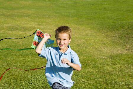Little boy running with a kiteの写真素材