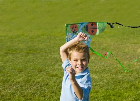 Little boy running with a kiteの写真素材