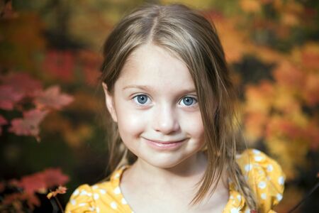 Portrait of a cute little girl outsideの写真素材