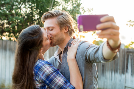 Cute couple taking selfies togetherの写真素材