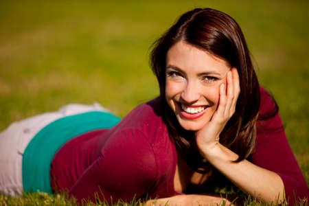 Pretty girl sitting in the grassの写真素材