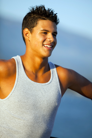 Young man standing on the pierの写真素材