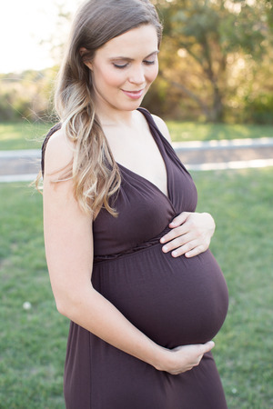 Beautiful pregnant woman holding tummyの写真素材