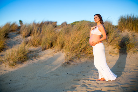 Beautiful pregnant woman at the beachの写真素材