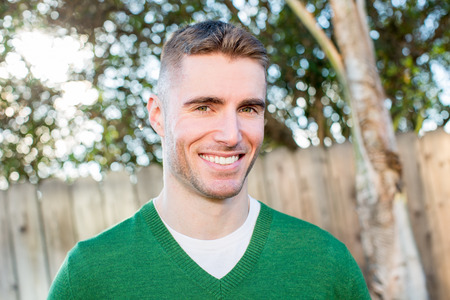 Portrait of friendly young man outsideの写真素材
