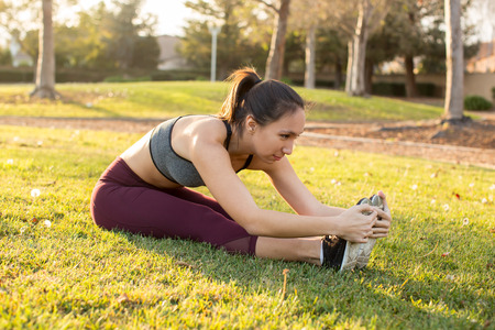 Young ethnic woman stretching for her workout