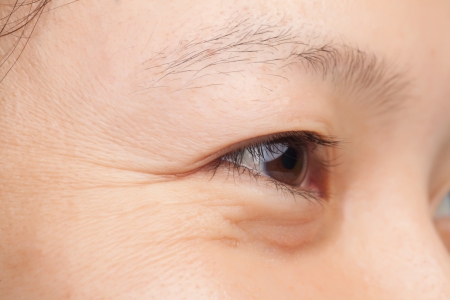 Middle-age woman face closeup wrinklesの写真素材