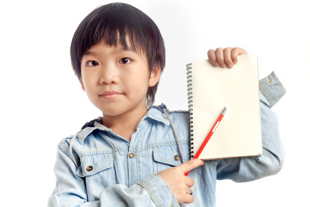 Boy holding blank notebook with pencil on white backgroundの写真素材